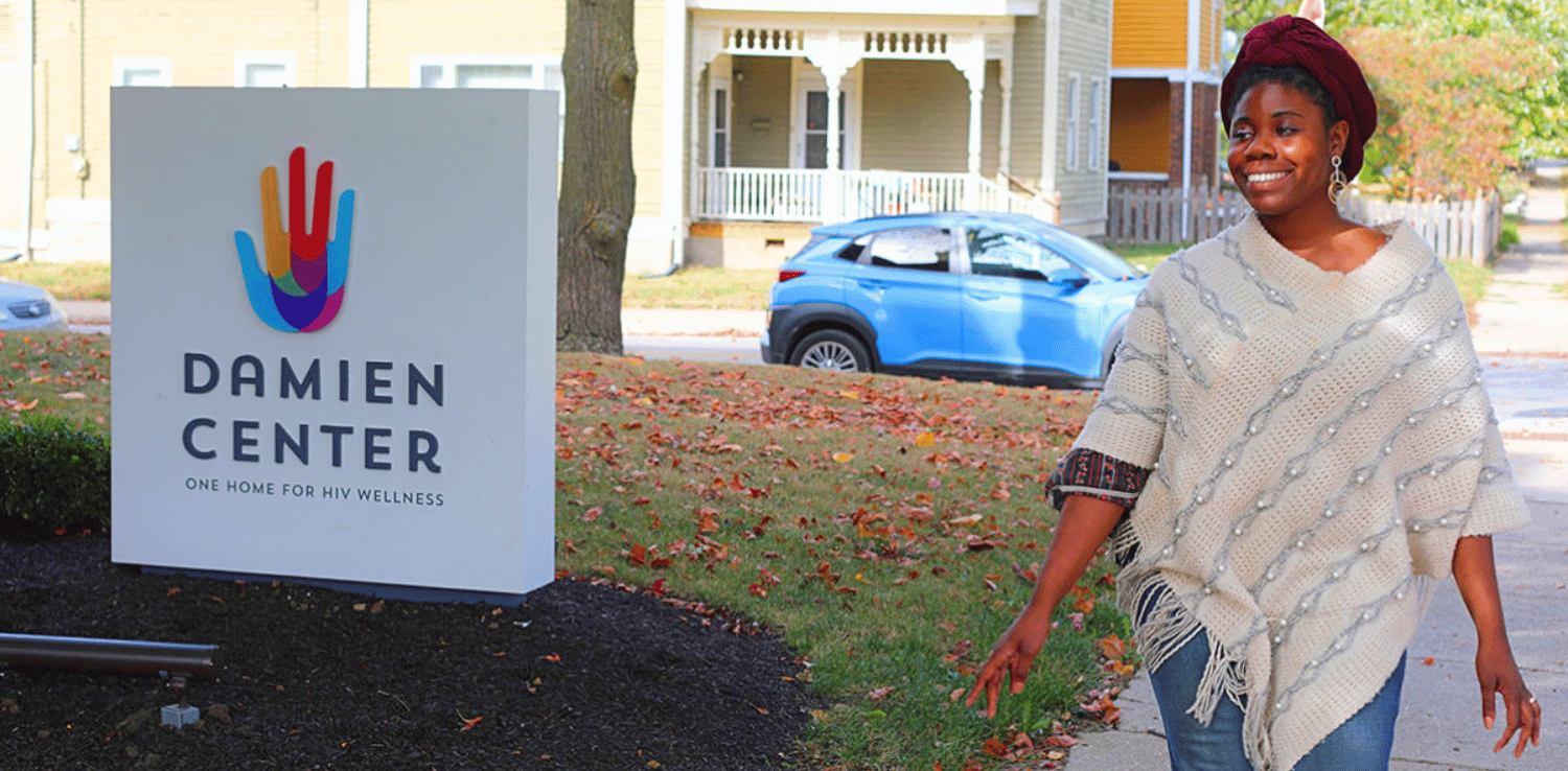 Woman walking in front of the Damien Center