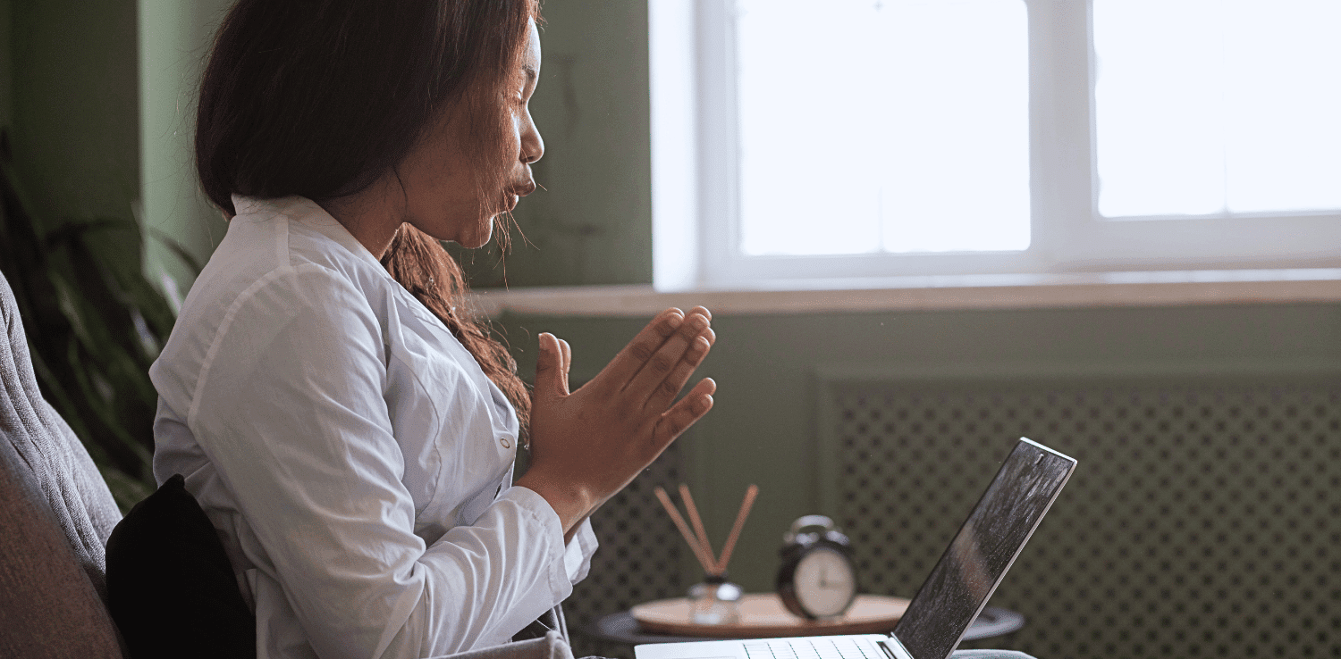 Woman in living room with laptop on her lap