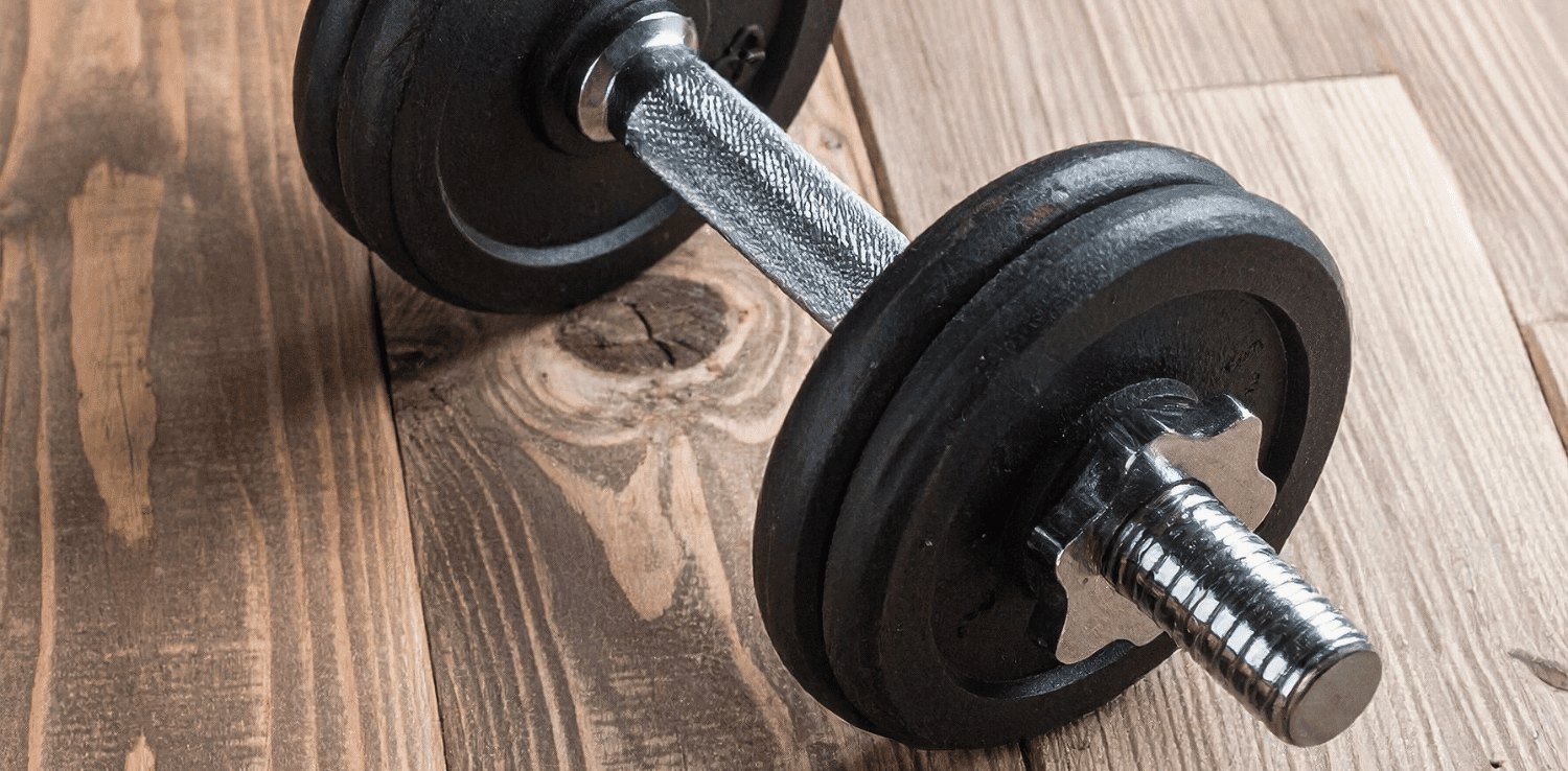 Hand dumbbell on a hardwood floor 