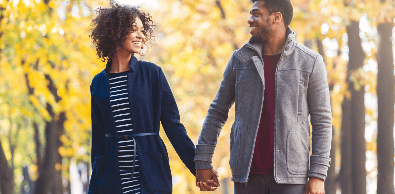 Couple walking hand-in-hand.