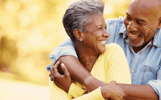 Couple hugging and smiling, proving that aging with hiv is better with connection